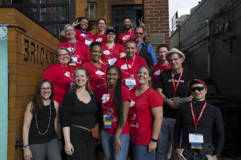 people standing together in similar t-shirts posing for a picture