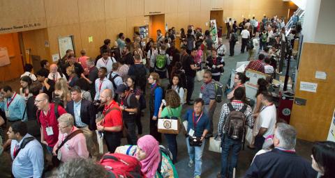 many people walking in a conference center