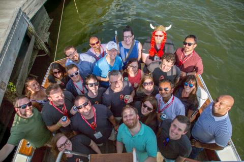 Group of people on a boat posing for picture