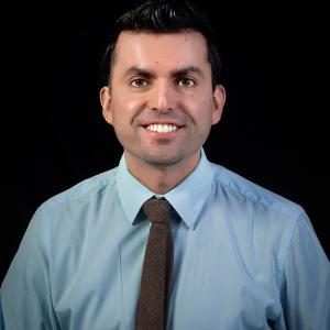 Daniel Ferro in a button up shirt and tie.